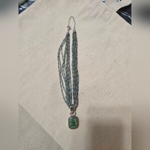 Lia Sophia multi-strand seed bead necklace with a green cameo-style pendant.
